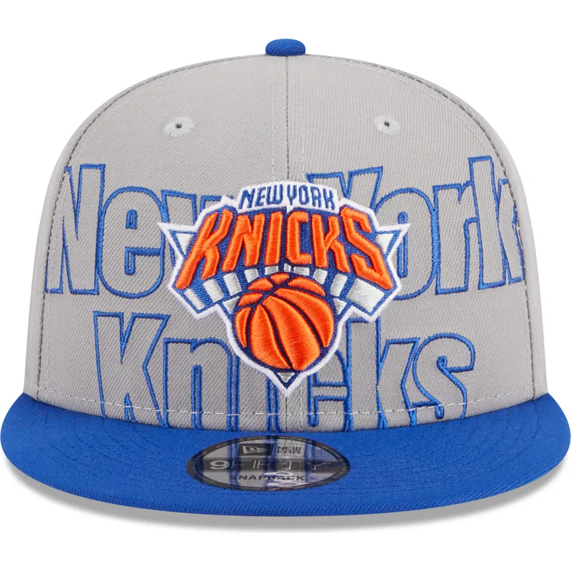 graue-und-blaue-flatcap-snapback-9fifty-draft-edition-2023-der-new-york-knicks-nba-von-new-era